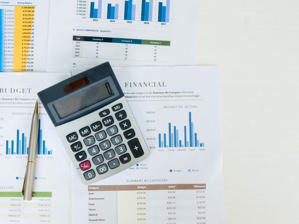 Charts, coins, and a calculator(hence the SIP Calculator) showing financial market analysis and planning tools.