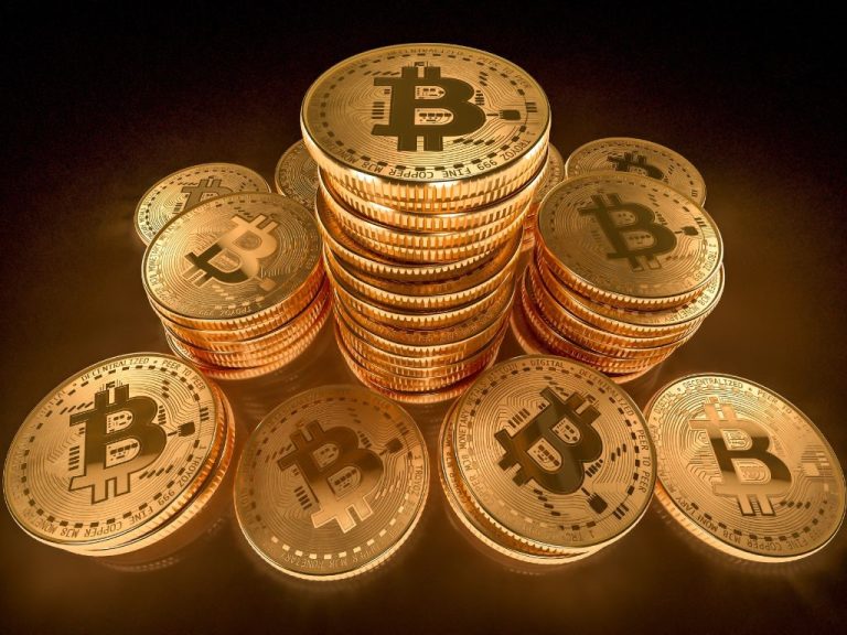 Stacks of golden Bitcoin coins illuminated in a glowing light, symbolizing cryptocurrency wealth and premium investments.