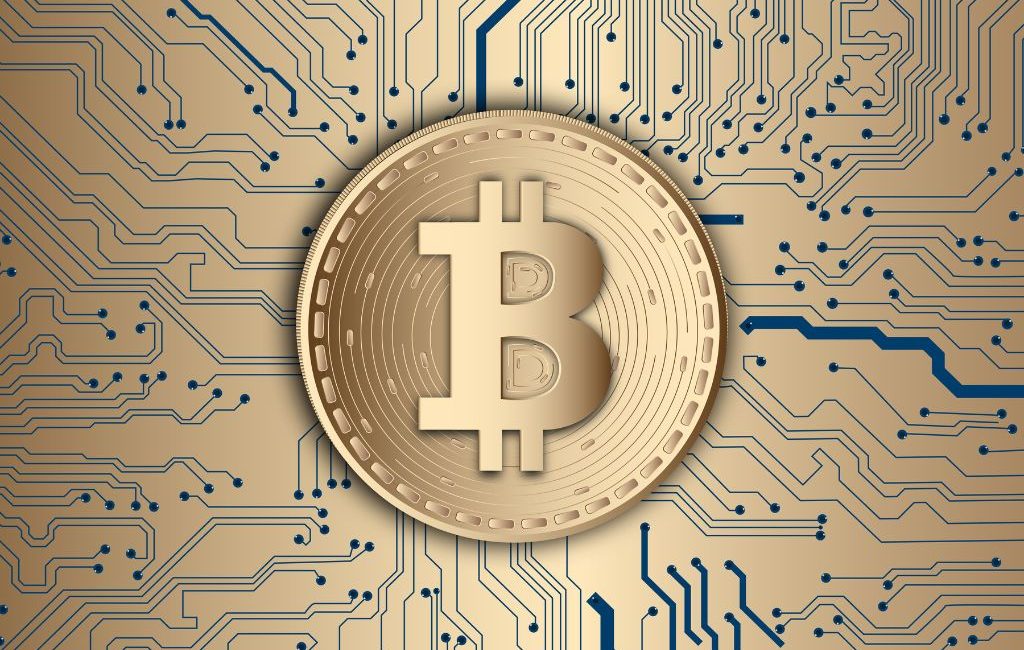 Golden Bitcoin symbol on a circuit board background, representing blockchain technology and digital finance.